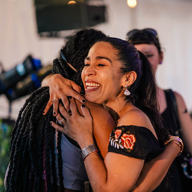 Close up of two people hugging.