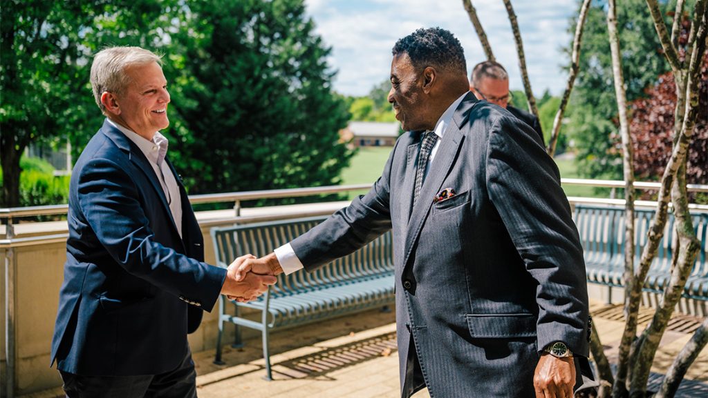 NC Governor Josh Stein shakes hands with UNCG Chancellor Gilliam.