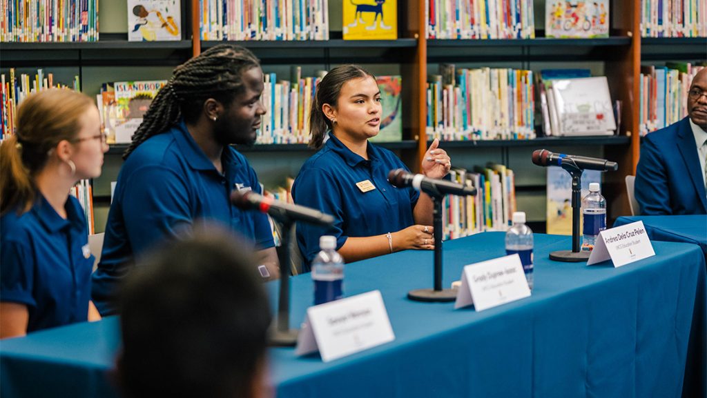 A UNCG student speaks into a microphone.